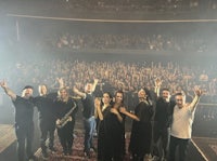 a group of people posing for a picture in a concert