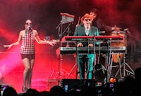 a group of people on stage with keyboards and microphones