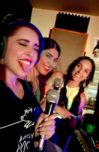 a group of women singing in a recording studio