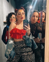 three women taking a selfie in a mirror