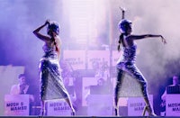 two dancers perform on stage at a concert