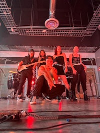 a group of people posing in front of a stage