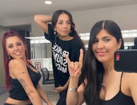 three women posing for a photo in a hair salon