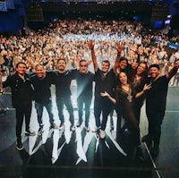 a group of people posing in front of an audience
