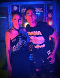 a man and woman standing next to each other at a party